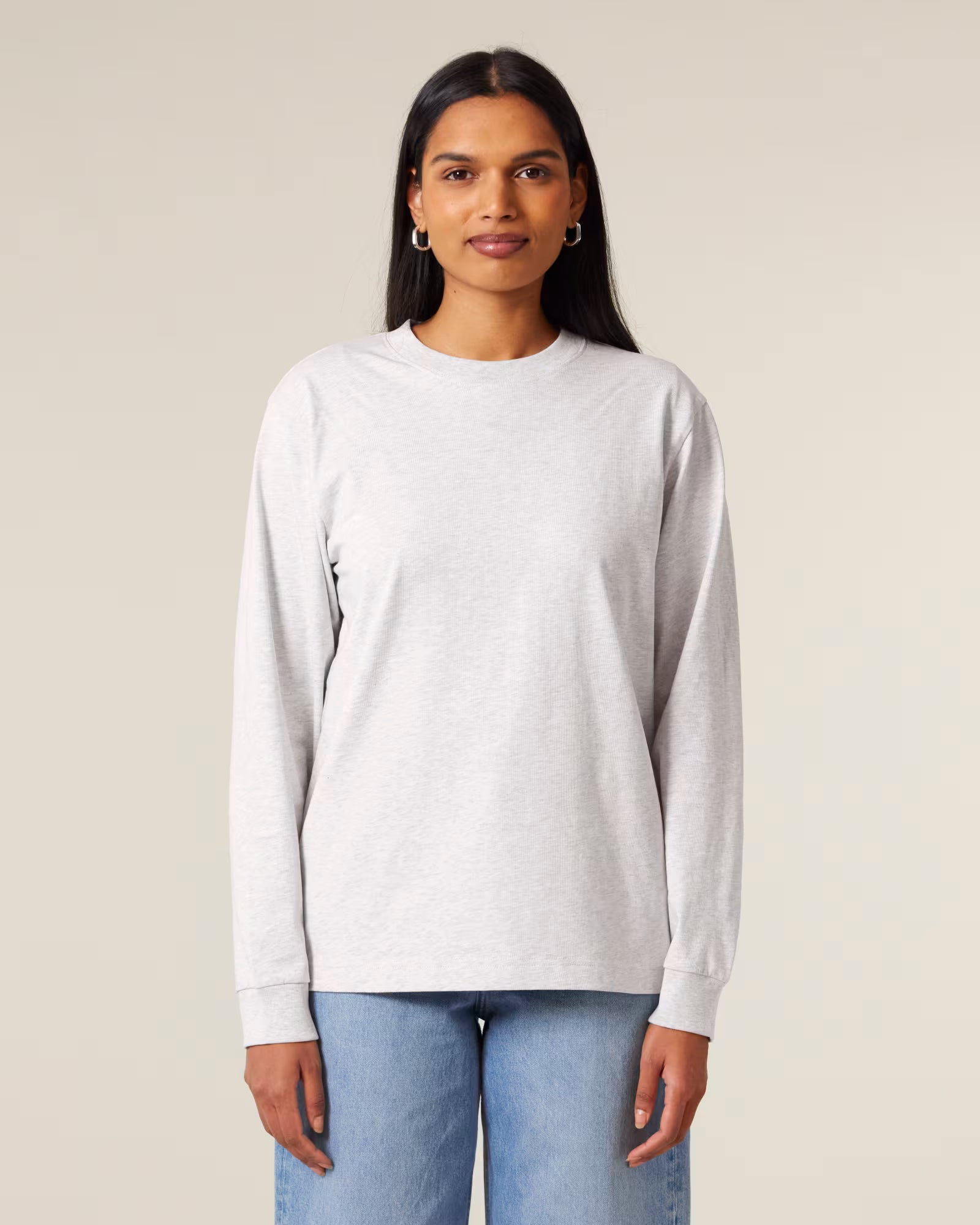 Front view of a women model wearing a white cotton long sleeve t-shirt in studio