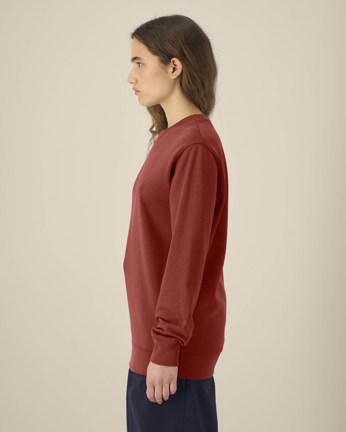 Person wearing a red unisex cotton hoodie isolated on white background