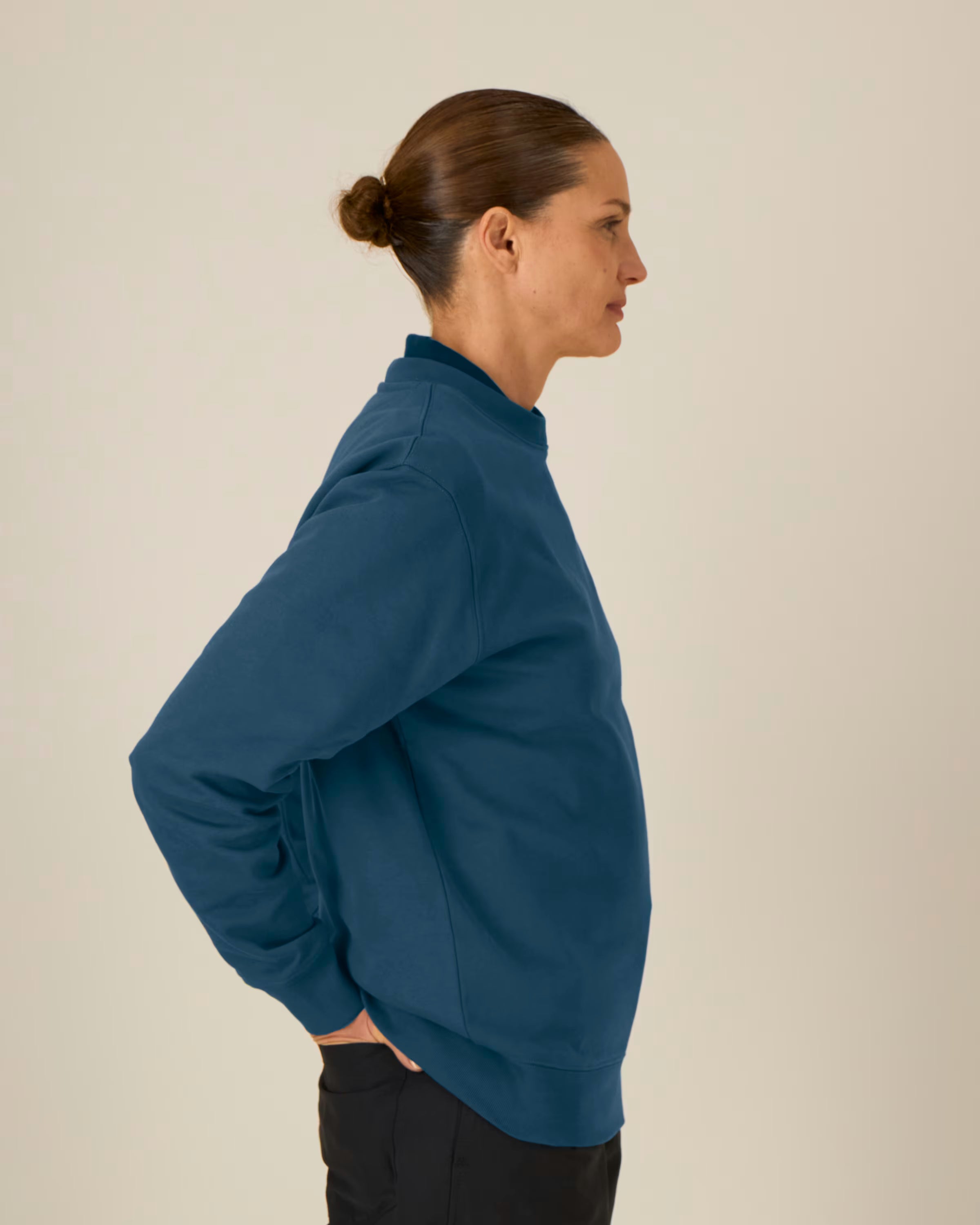 deep navy unisex crewneck sweatshirt on model, side view