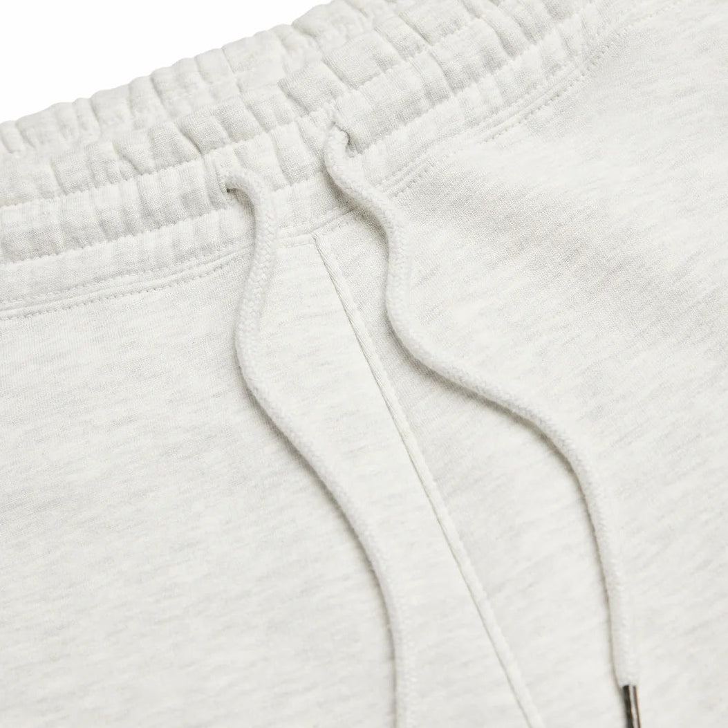 Close-up of light gray sweatpants with a zipper detail 