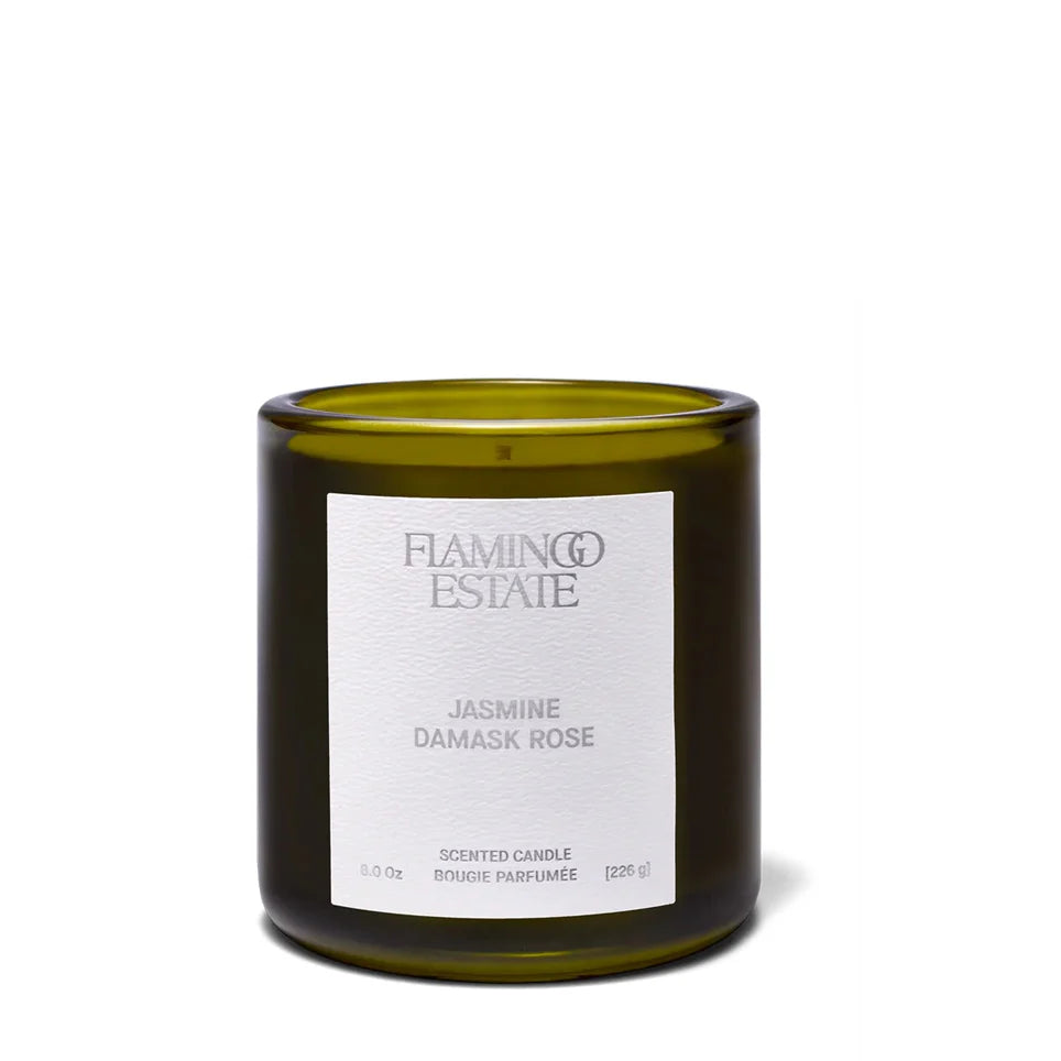 Green candle with a white label on a white background