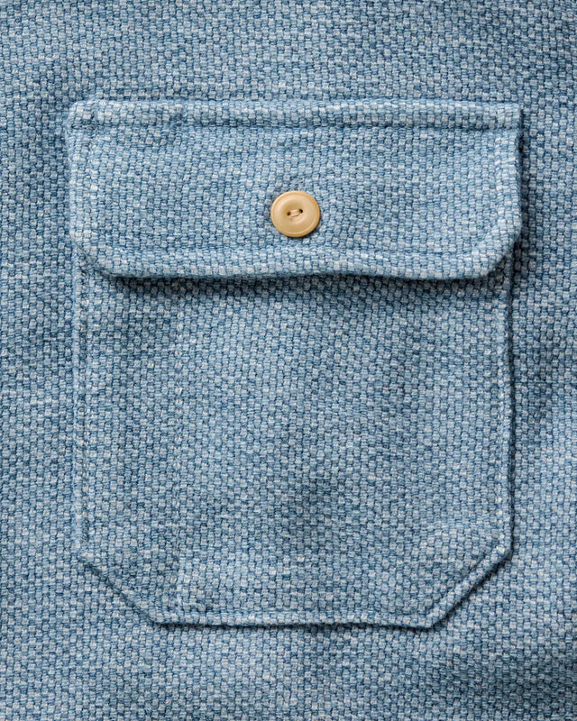 Chest pocket detail on indigo blue men’s shirt