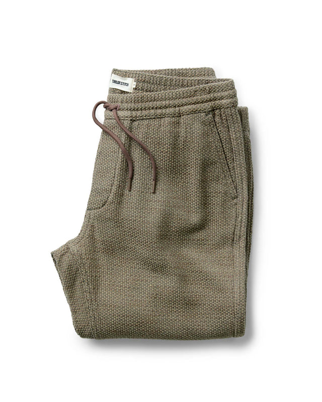 Olive green men’s jogger pants with elastic waistband and drawstring