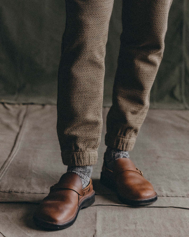 Close up of olive green jogger pants with cuffed hem